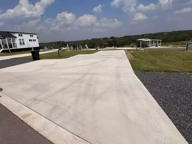 a view of swimming pool with a yard and large trees