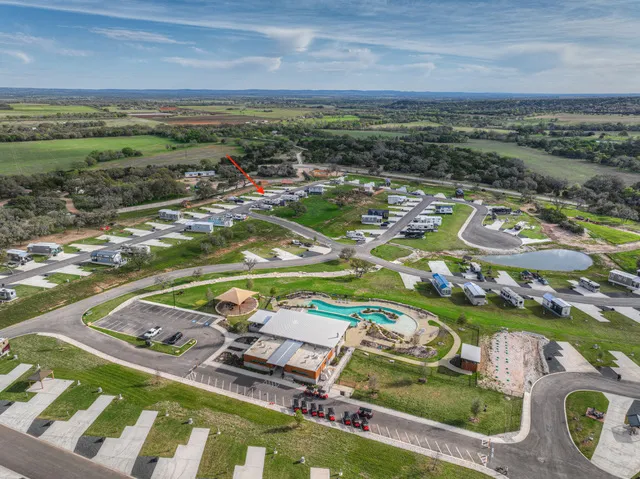 an aerial view of a pool yard and outdoor seating