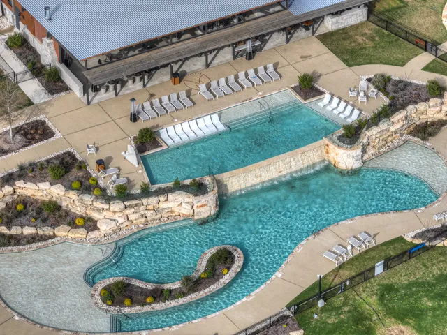 a backyard of a house with outdoor seating and trees