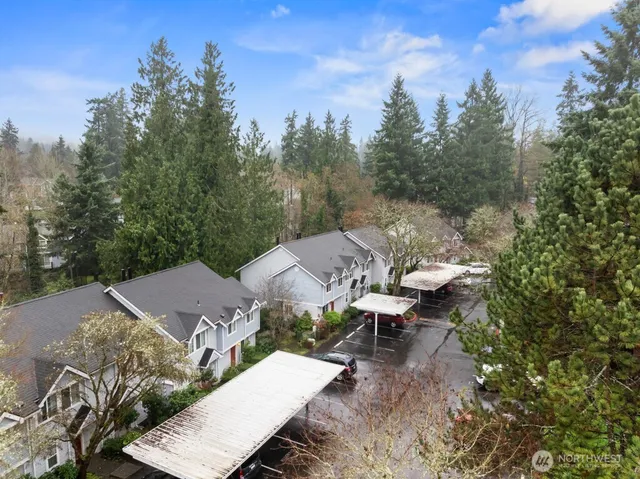 an aerial view of a house with yard and mountain view in back