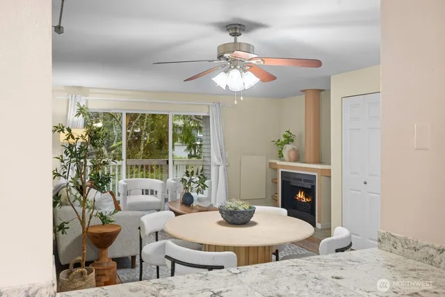 a living room with furniture a chandelier and a fireplace