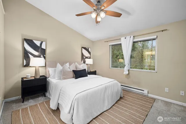 a bedroom with double bed and a large window