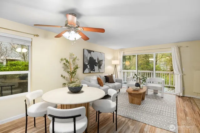 a living room with furniture a chandelier and a large window