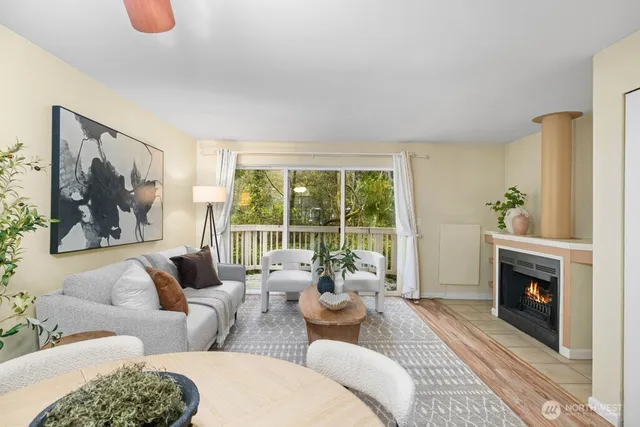 a living room with furniture large window and fire place
