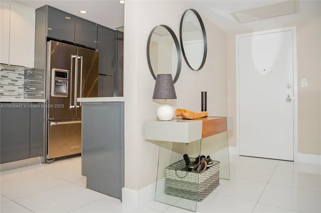 a room with round mirror and cabinets