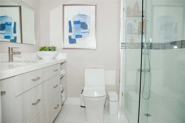 a bathroom with a toilet sink vanity and mirror