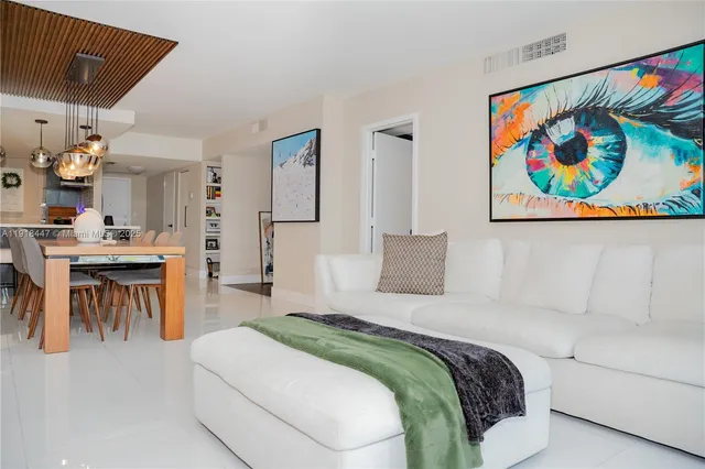 a spacious bedroom with a bed and a painting on the wall