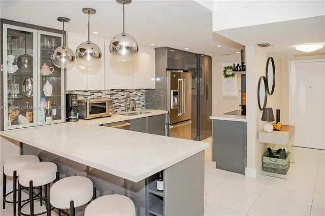 a very nice looking dining room with kitchen island furniture and a chandelier