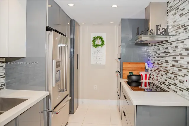 a kitchen with stainless steel appliances granite countertop a refrigerator and a sink