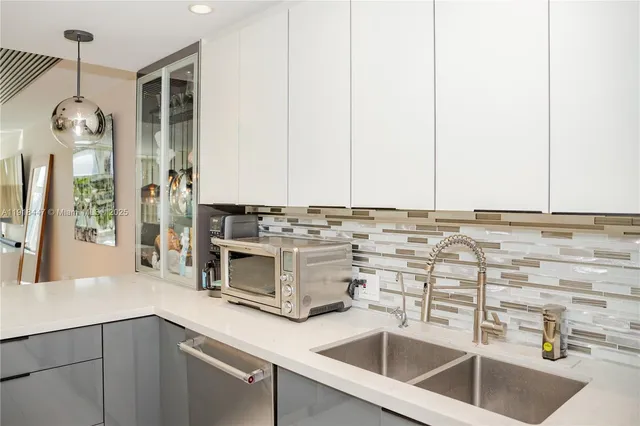 a kitchen with stainless steel appliances granite countertop a sink and cabinets