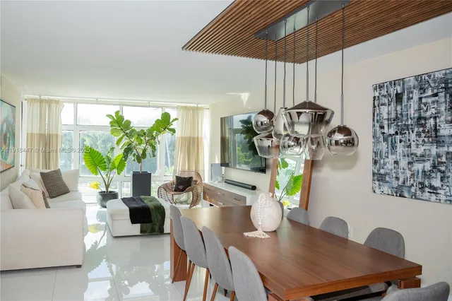 a view of a dining room with furniture one side kitchen view
