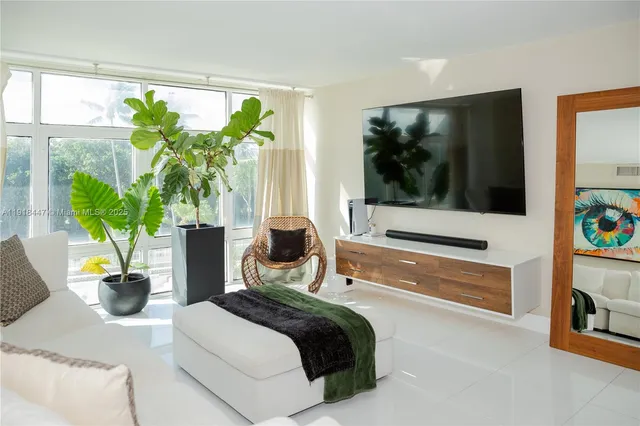 a bedroom with a bed table and a potted plant