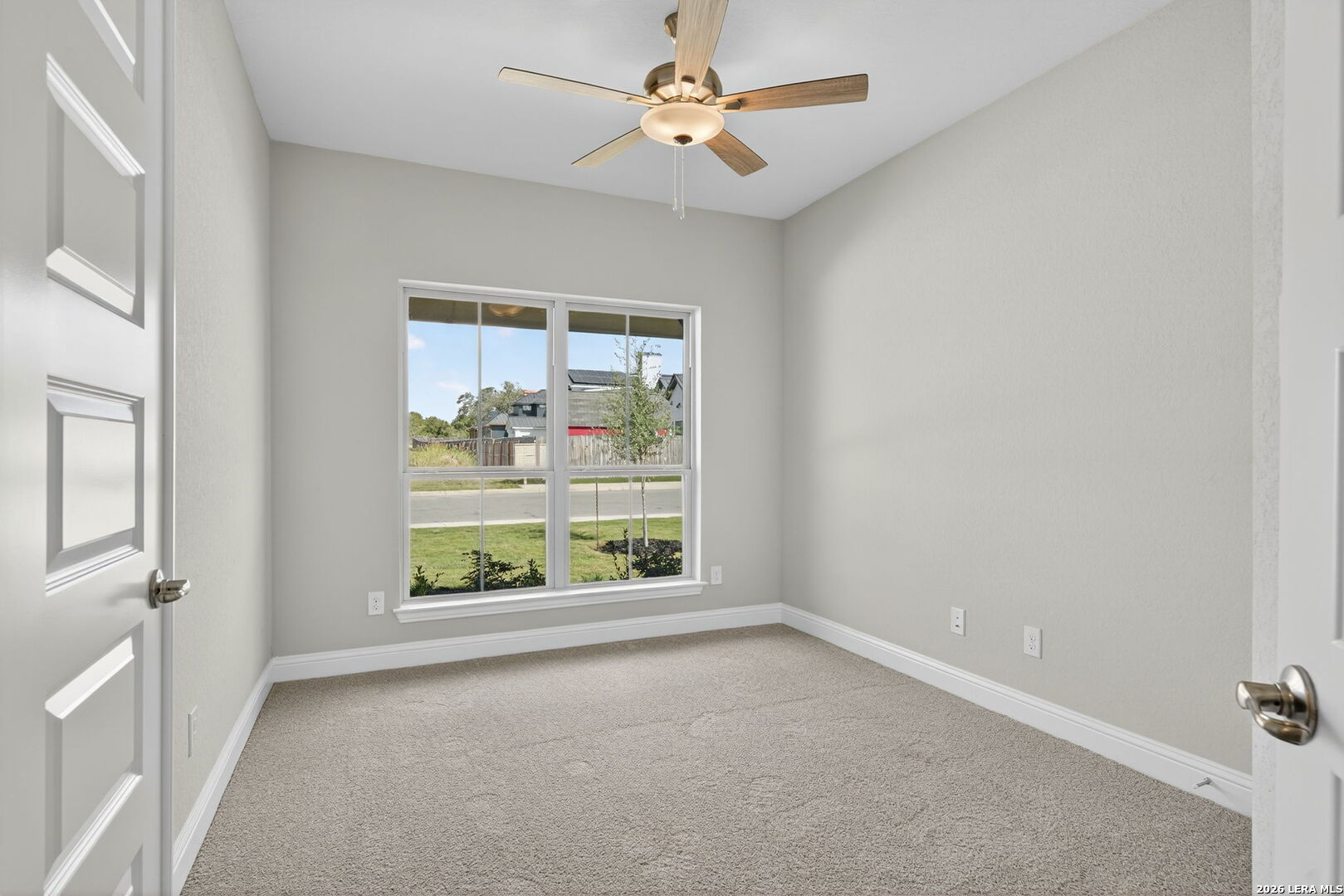 254 Allen Avenue Castroville, TX 78009 - Photo 12 of 24 an empty room with windows and ceiling fan