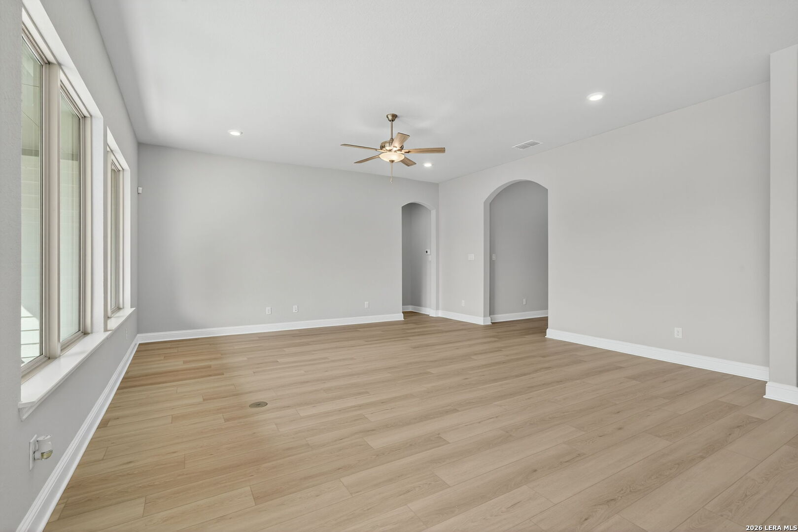 254 Allen Avenue Castroville, TX 78009 - Photo 4 of 24 wooden floor in an empty room with a window