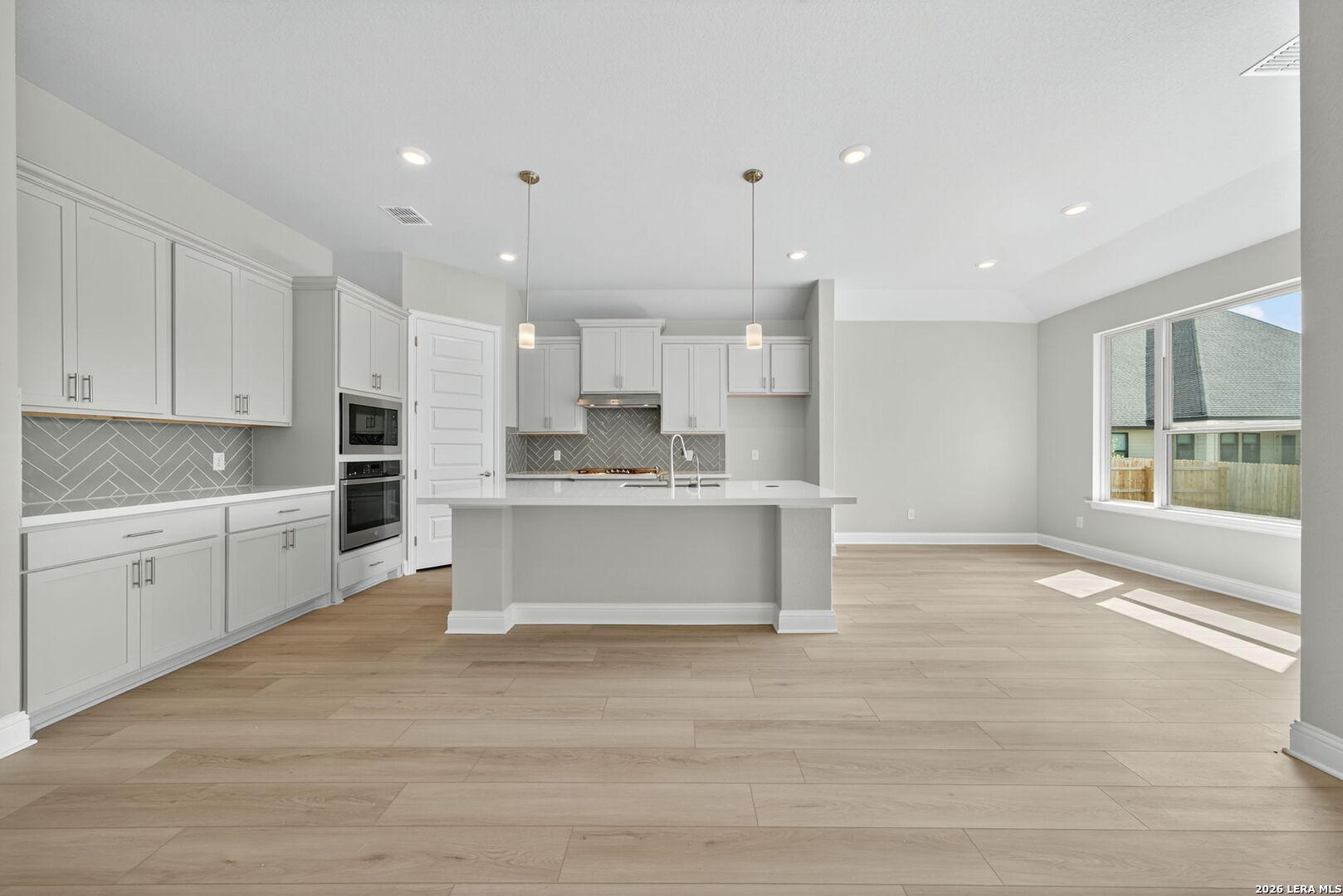 254 Allen Avenue Castroville, TX 78009 - Photo 7 of 24 a large kitchen with kitchen island a sink stainless steel appliances and cabinets