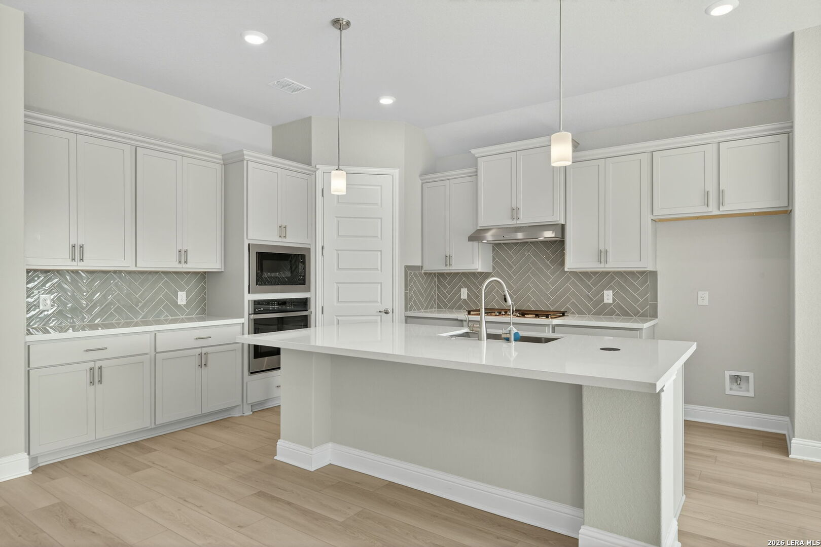 254 Allen Avenue Castroville, TX 78009 - Photo 8 of 24 a kitchen with kitchen island a sink stainless steel appliances and cabinets