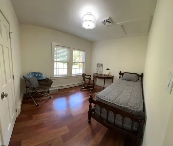 a bedroom with furniture and a window
