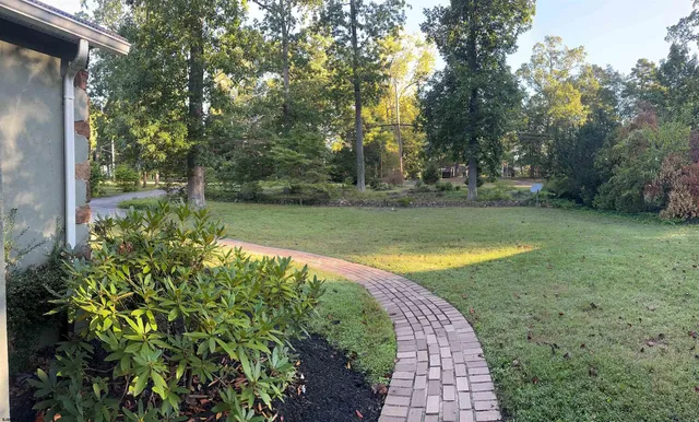 a view of a swimming pool with a yard