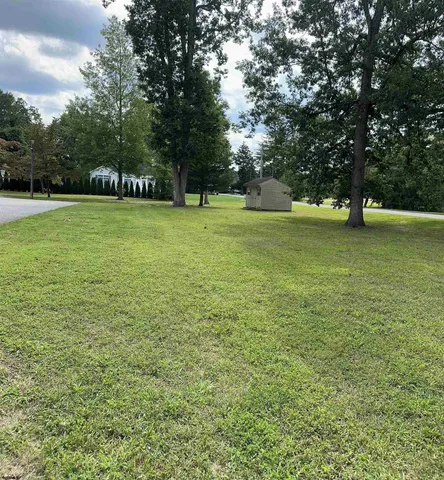a view of a park with trees in the background