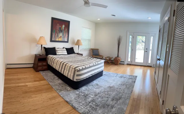 a bedroom with a bed lamp closet and large window