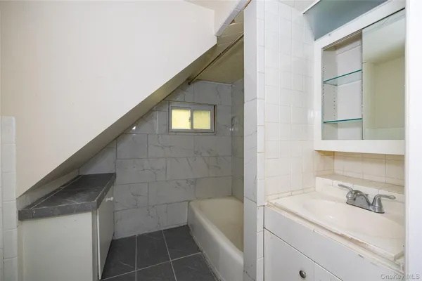 a bathroom with a sink a toilet and bathtub