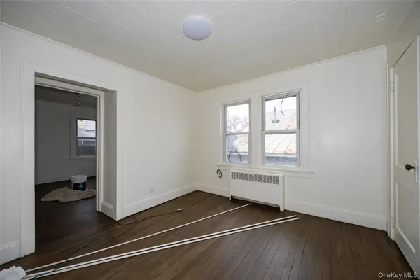 an empty room with windows and closet