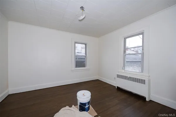 a view of a livingroom with wooden floor and a window