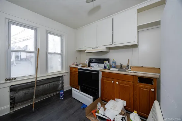 a kitchen with granite countertop a stove and a sink