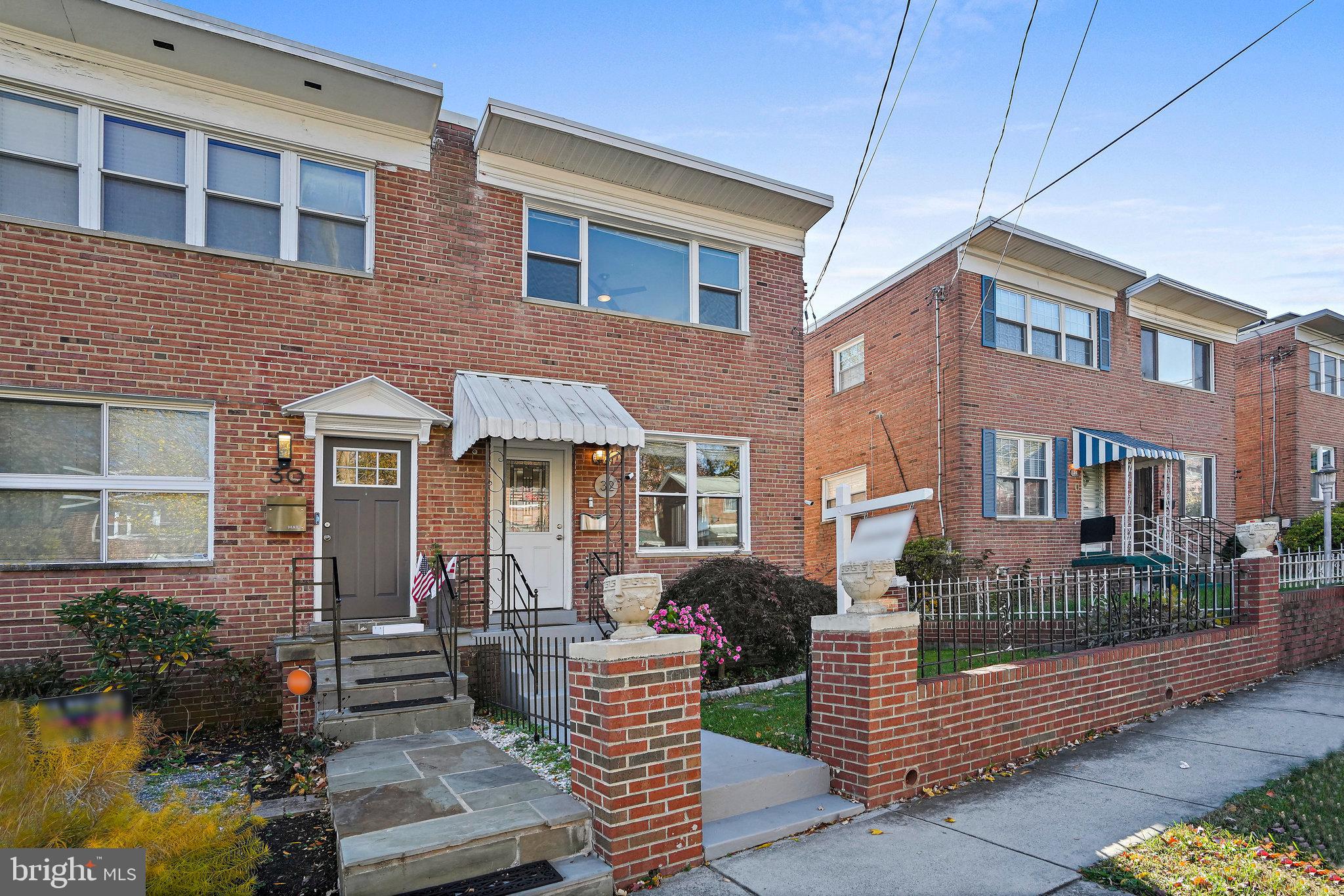 a front view of a house with garden and patio