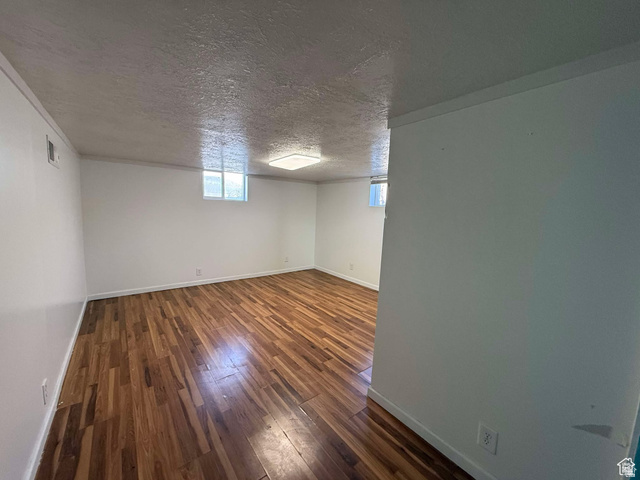 73 Garden Street Helper, UT 84526 - Photo 23 of 36 Basement featuring dark wood finished floors and a textured ceiling