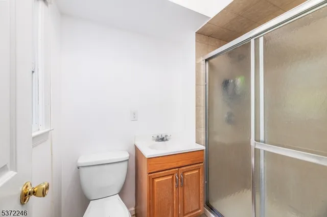 an aerial view of residential house with outdoor space and trees all around