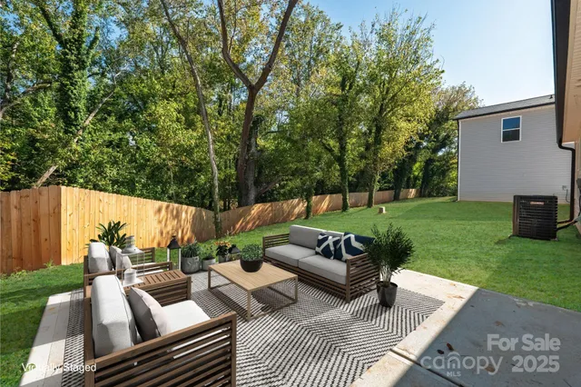 a view of a couches in patio of back yard
