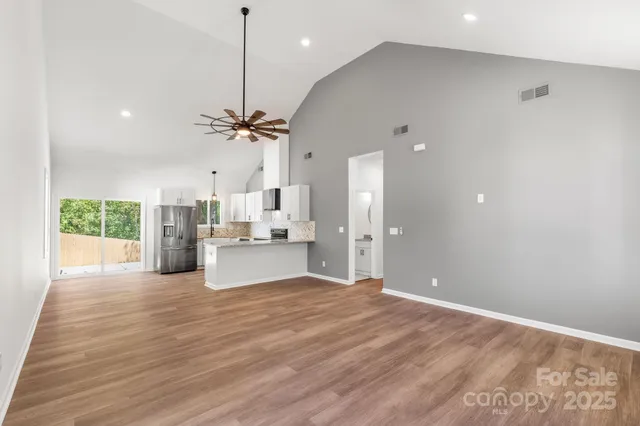 a view of a kitchen with a sink hardwood floor and a ceiling fan