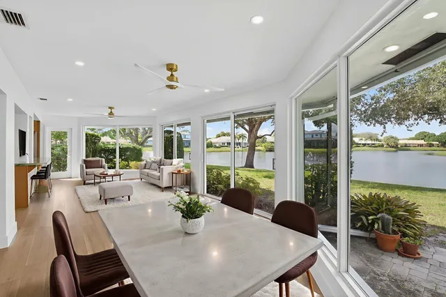 a kitchen with kitchen island granite countertop wooden cabinets and white stainless steel appliances