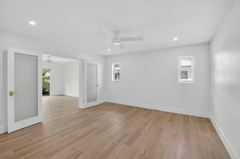 a living room with furniture a bookshelf and a large window
