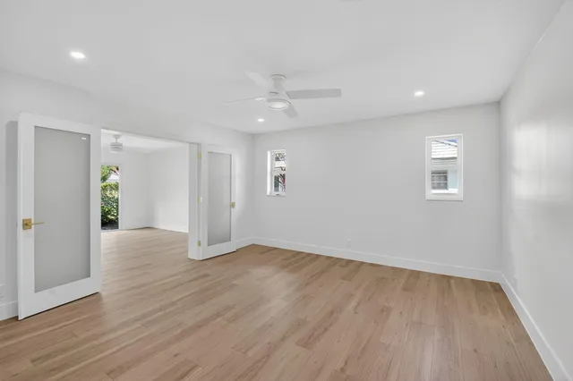 a living room with furniture a bookshelf and a large window