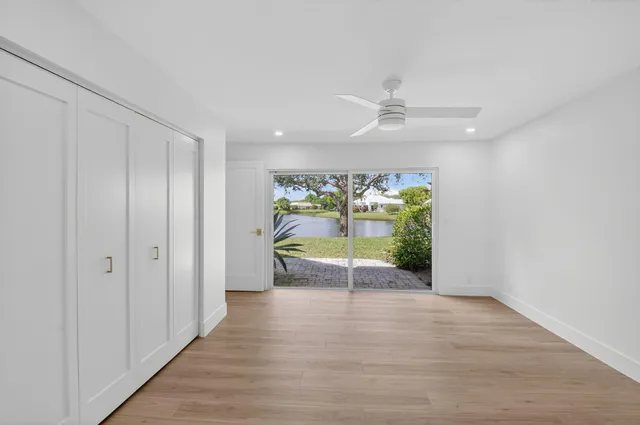 a bedroom with a large bed and a flat screen tv