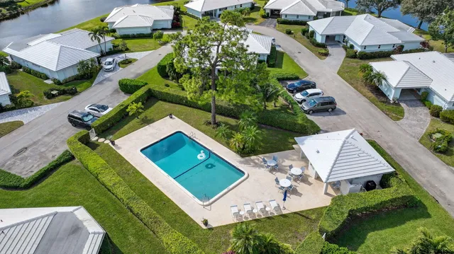 an aerial view of a house with swimming pool garden and patio
