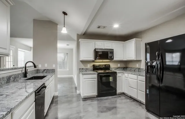 a kitchen with stainless steel appliances granite countertop a sink stove oven and refrigerator