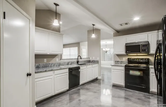 a kitchen with a sink stove and microwave