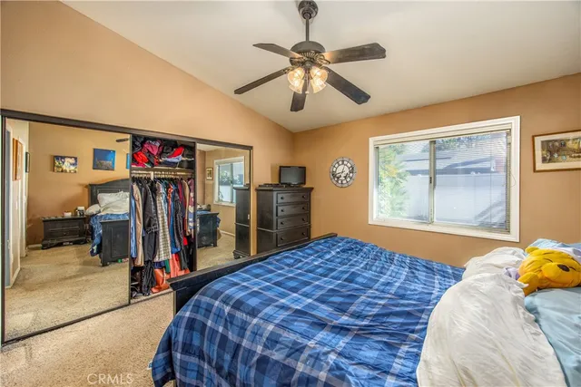 a bedroom with a large bed and a window