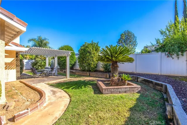a view of a backyard with plants and a patio