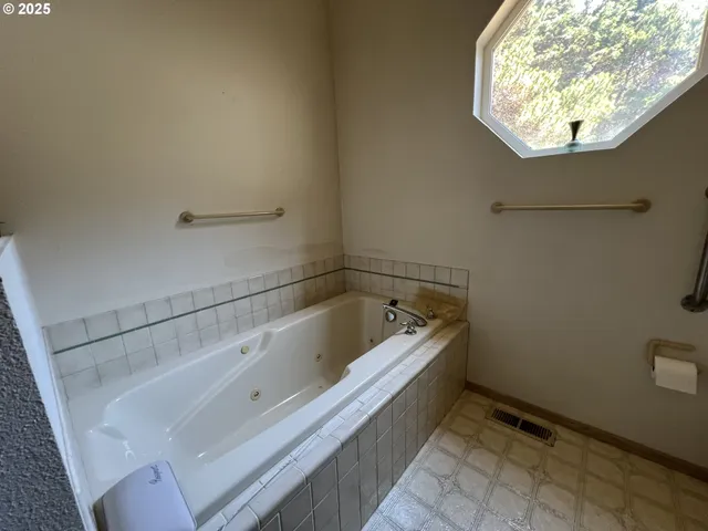 a bathroom with a bathtub and a shower