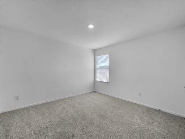 a view of an empty room and a window