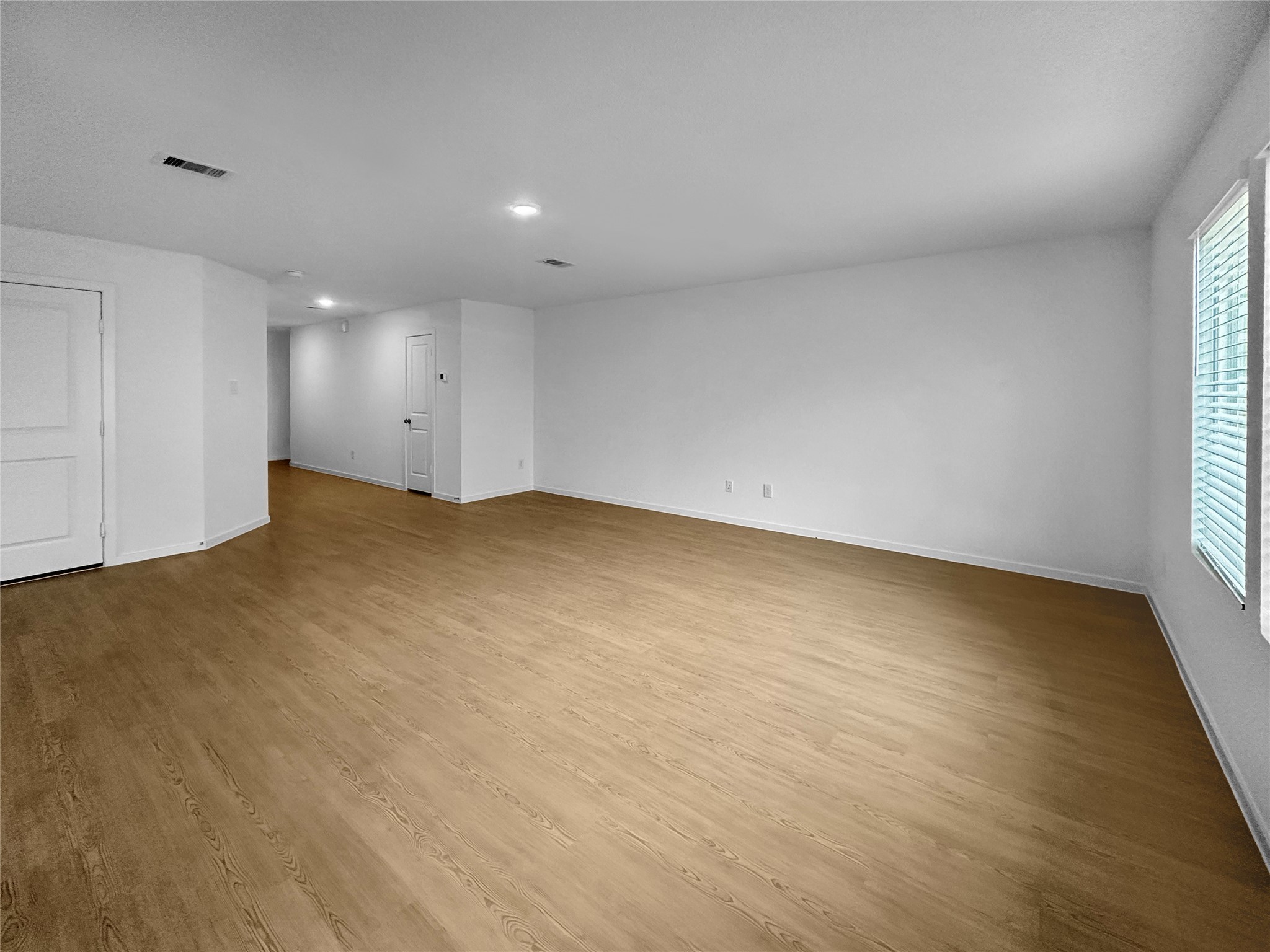 31460 Moore Road Magnolia, TX 77354 - Photo 2 of 17 an empty room with wooden floor and windows