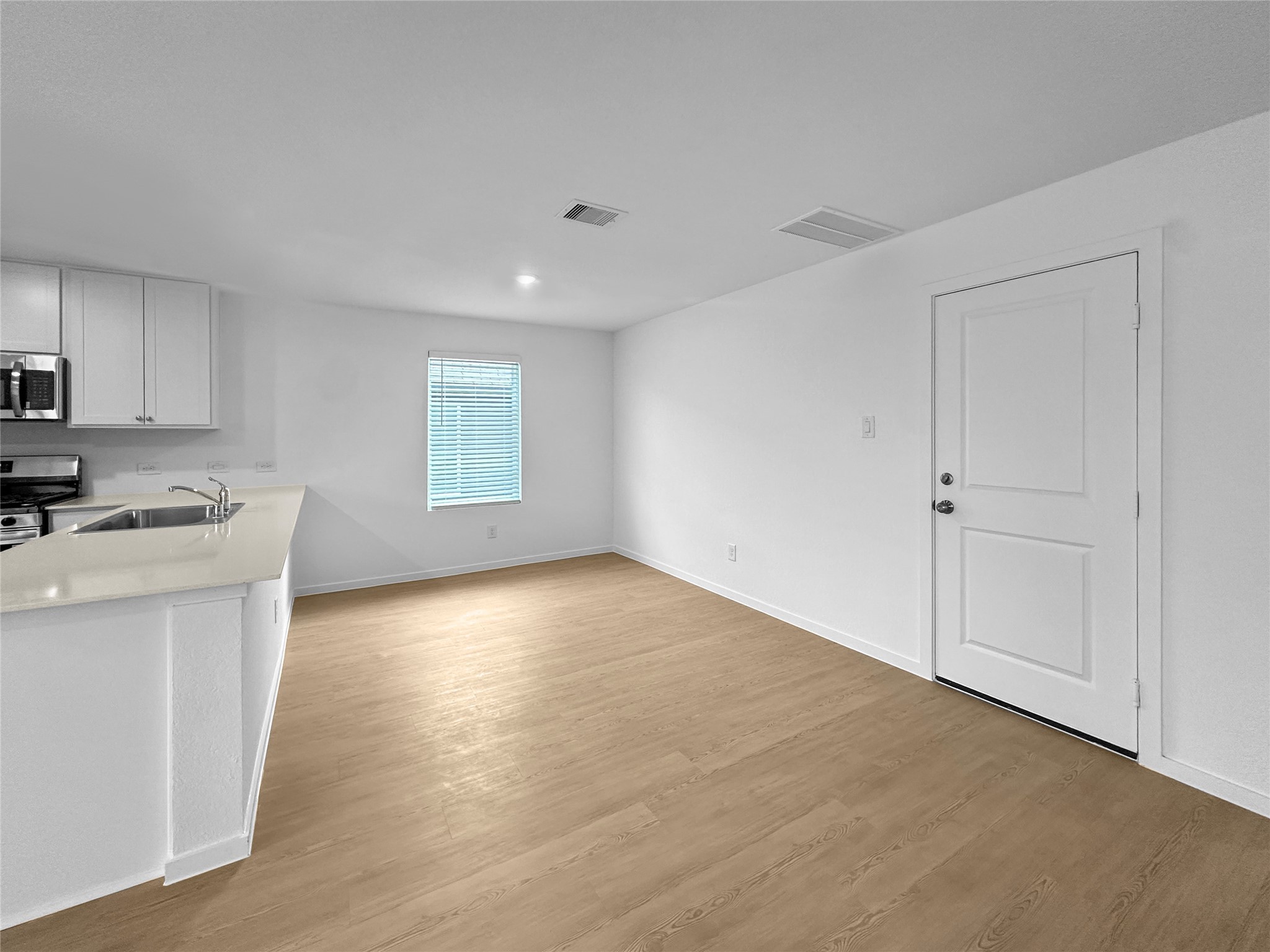 31460 Moore Road Magnolia, TX 77354 - Photo 3 of 17 a view of an empty room with window and wooden floor
