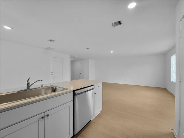 a kitchen with a sink and cabinets