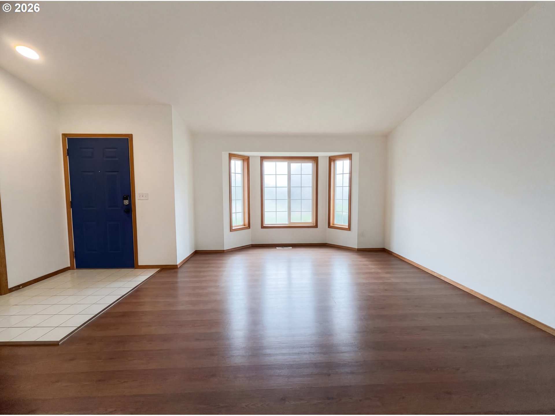 8641 Northeast Windstone Street Beaverton, OR 97006 - Photo 11 of 18 a view of an empty room with window and wooden floor
