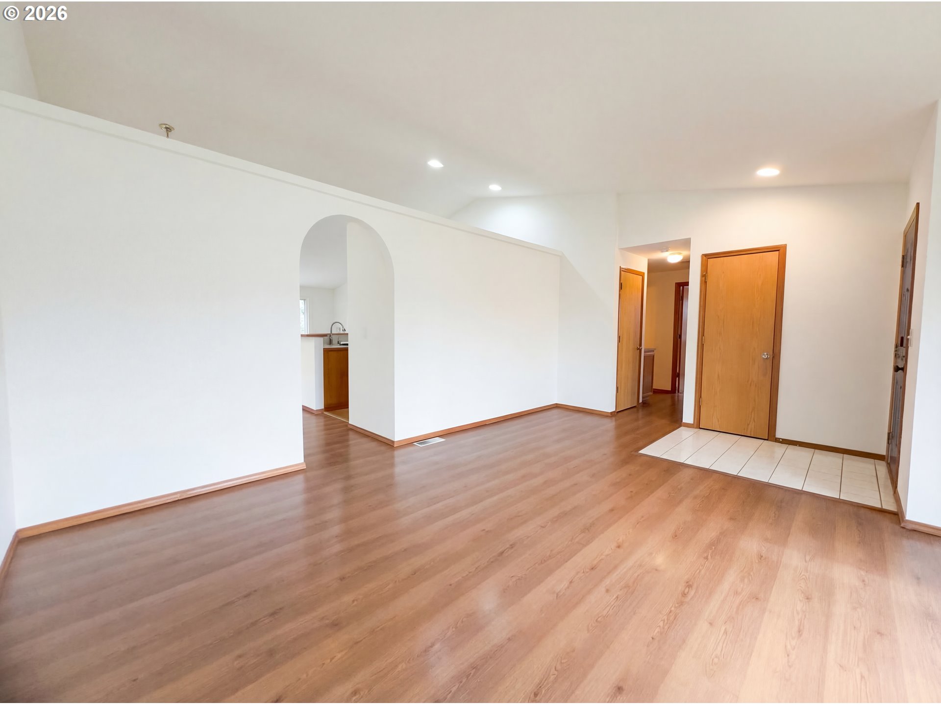8641 Northeast Windstone Street Beaverton, OR 97006 - Photo 12 of 18 a view of an empty room with wooden floor and a window