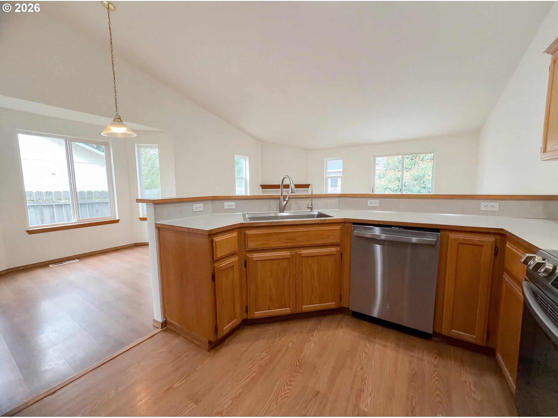 8641 Northeast Windstone Street Beaverton, OR 97006 - Photo 15 of 18 a kitchen with granite countertop a sink cabinets and window